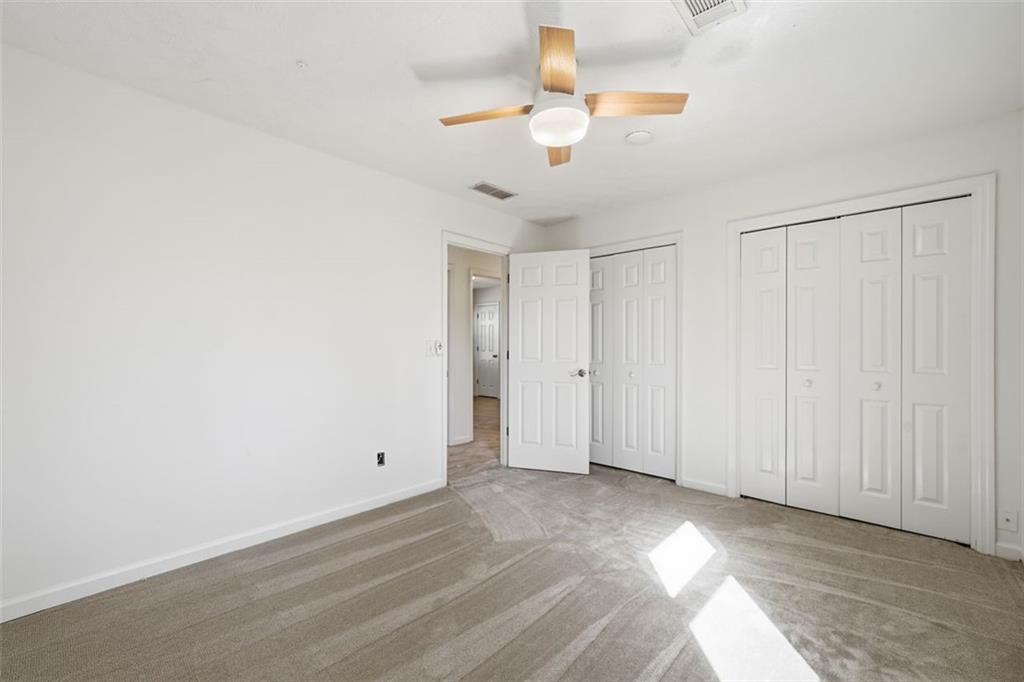 130 Spring Ridge Court Roswell, GA 30076 - Photo 25 of 47 an empty room with a ceiling fan