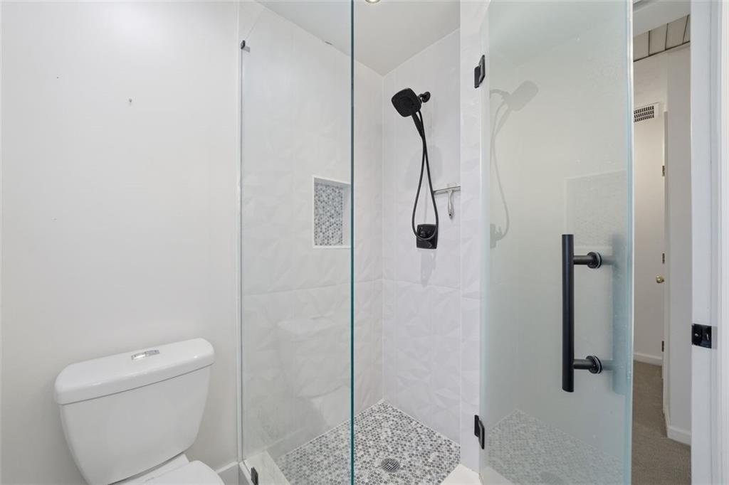 130 Spring Ridge Court Roswell, GA 30076 - Photo 27 of 47 a bathroom with a shower toilet and sink