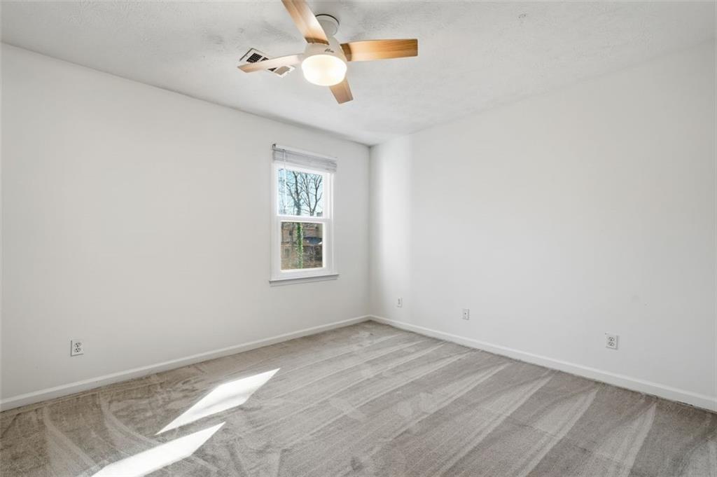 130 Spring Ridge Court Roswell, GA 30076 - Photo 28 of 47 an empty room with windows and fan