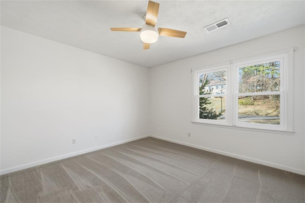 130 Spring Ridge Court Roswell, GA 30076 - Photo 30 of 47 an empty room with a window and a fan