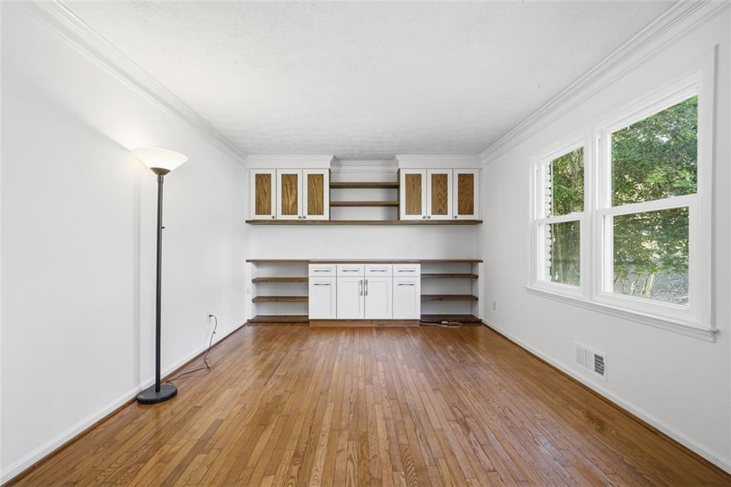 130 Spring Ridge Court Roswell, GA 30076 - Photo 4 of 47 a living room with stainless steel appliances wooden floor and a window