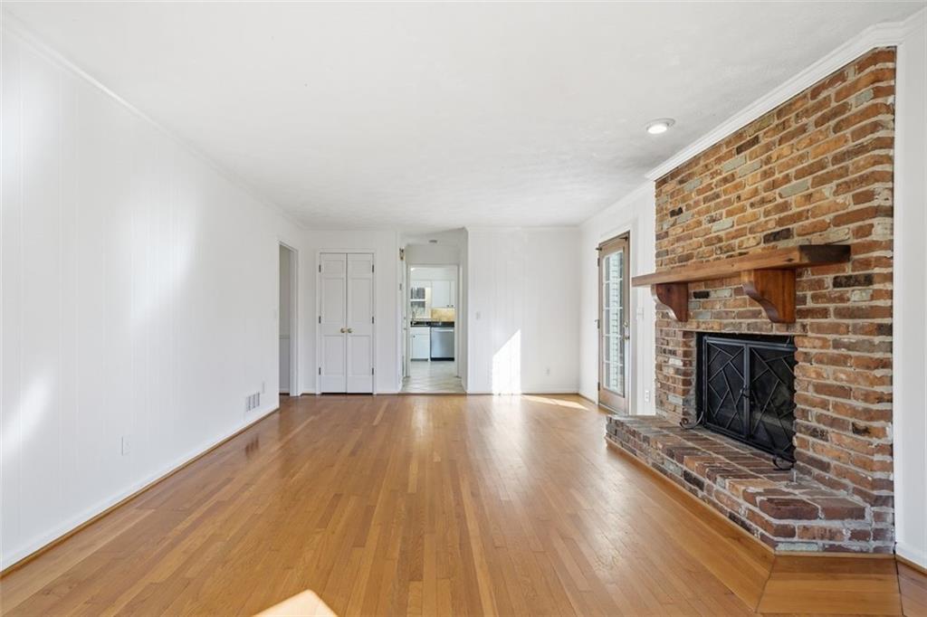 130 Spring Ridge Court Roswell, GA 30076 - Photo 9 of 47 a view of an empty room with wooden floor fire place