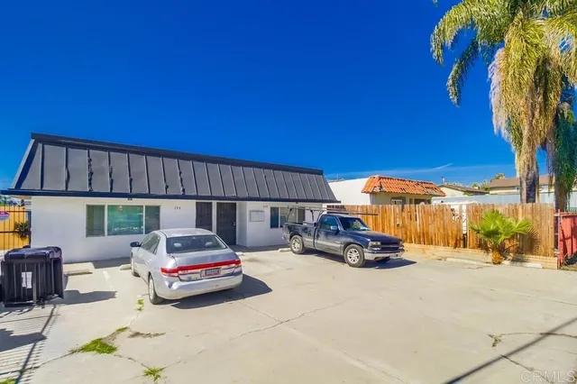 a car parked in front of a house with a yard