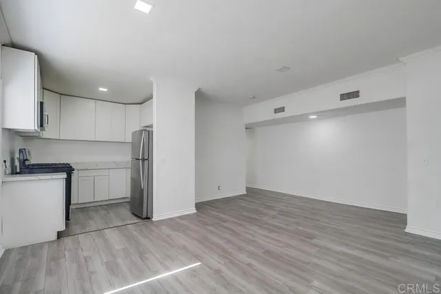 a view of a kitchen with a sink and a refrigerator