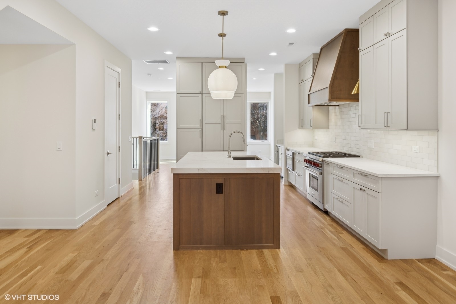 3740 North Racine Avenue, Unit 2 Chicago, IL 60613 - Photo 4 of 10 a large kitchen with a sink a counter space and stainless steel appliances