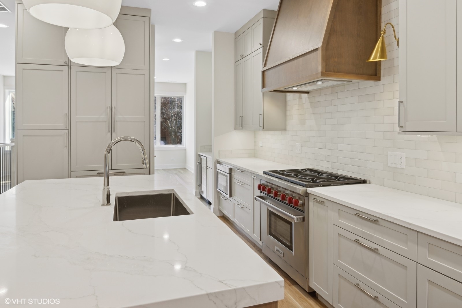 3740 North Racine Avenue, Unit 2 Chicago, IL 60613 - Photo 5 of 10 a kitchen with stainless steel appliances granite countertop a sink a stove and a refrigerator