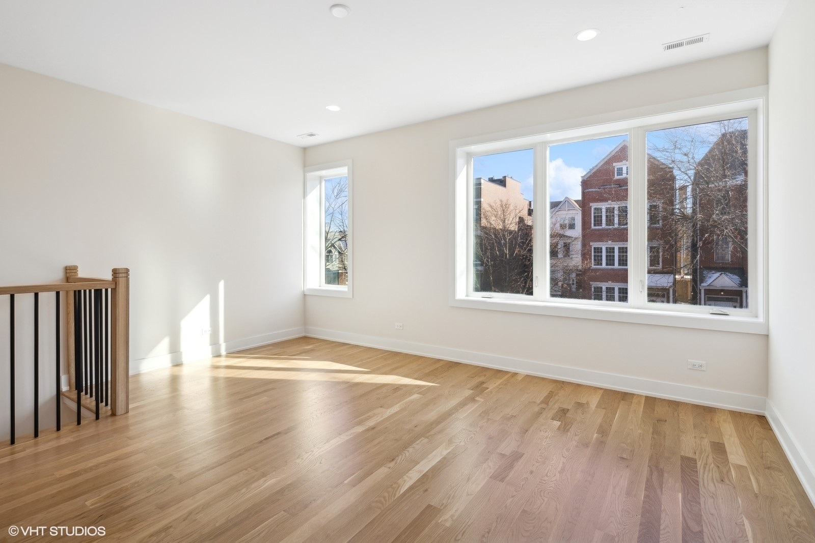 3740 North Racine Avenue, Unit 2 Chicago, IL 60613 - Photo 7 of 10 a view of an empty room with wooden floor and a window