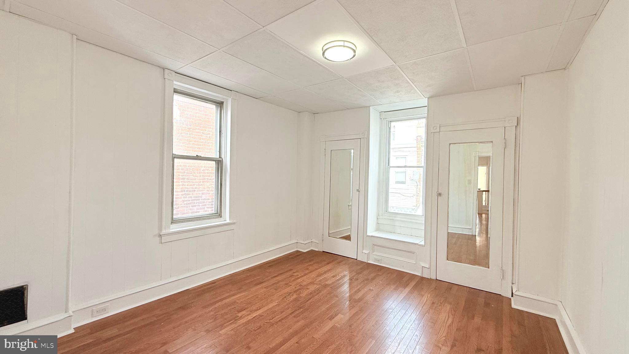 1333 Colwyn Street Philadelphia, PA 19140 - Photo 19 of 38 an empty room with wooden floor and windows