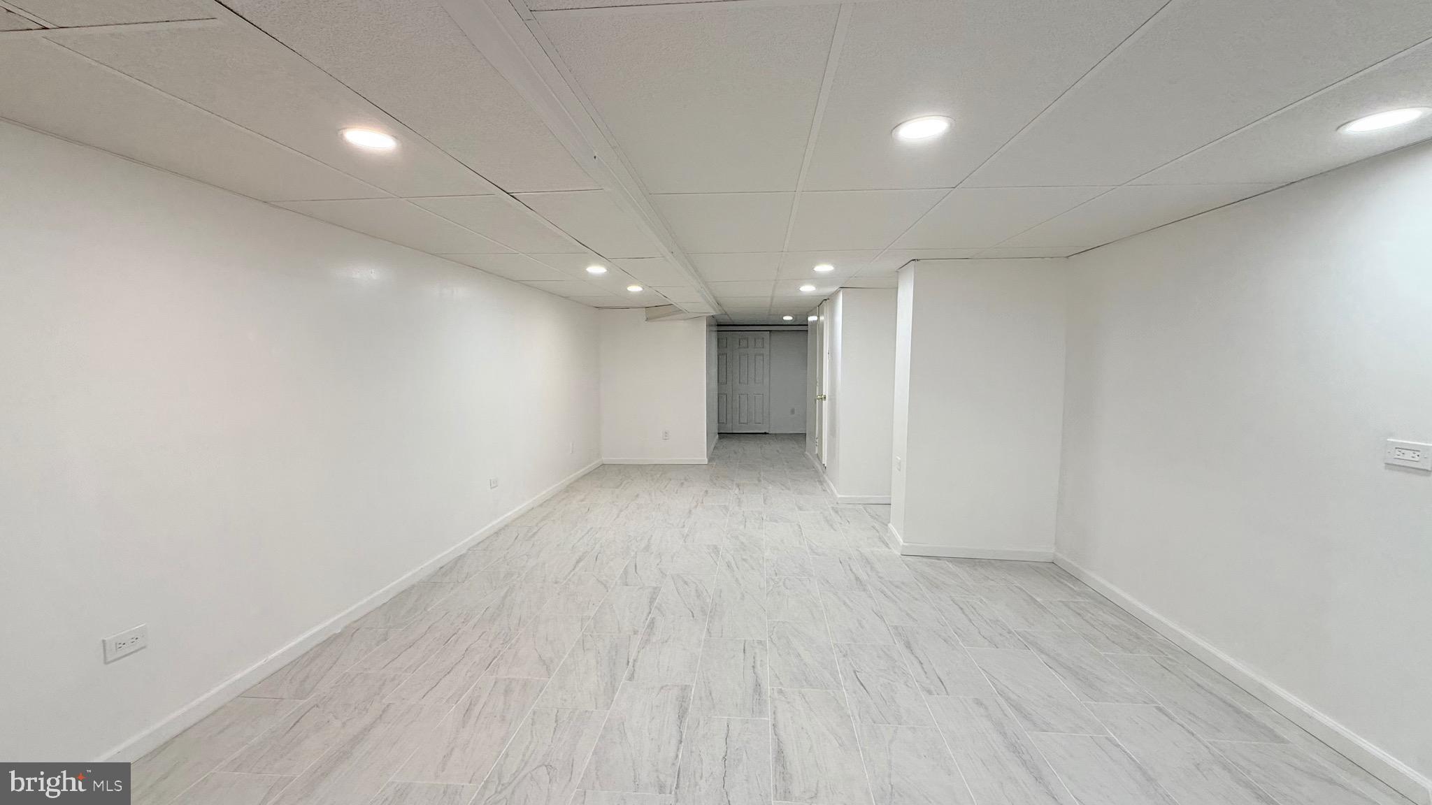 1333 Colwyn Street Philadelphia, PA 19140 - Photo 23 of 38 an empty room with wooden floor and natural light