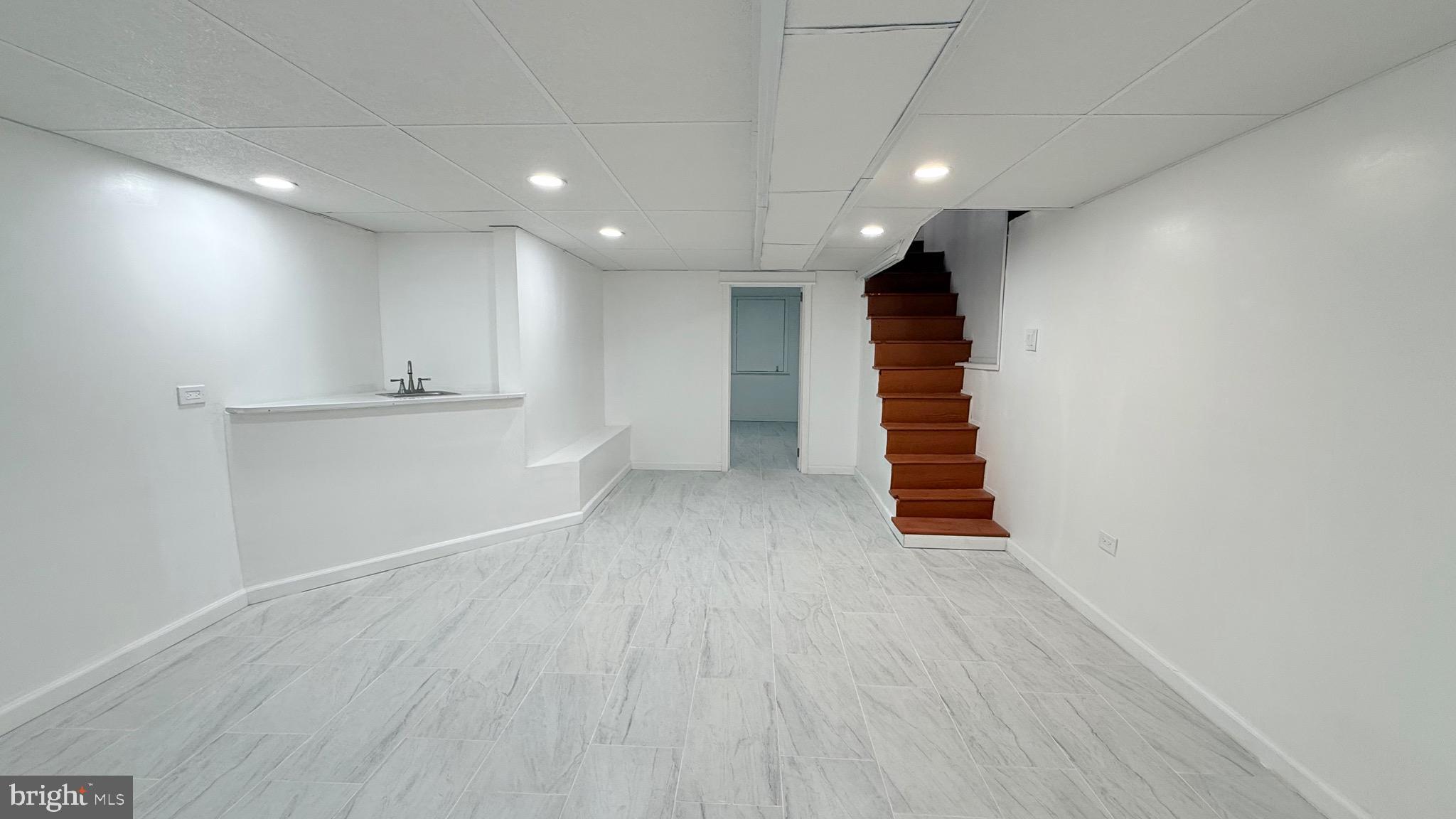 1333 Colwyn Street Philadelphia, PA 19140 - Photo 24 of 38 a view of empty room with stairs and wooden floor