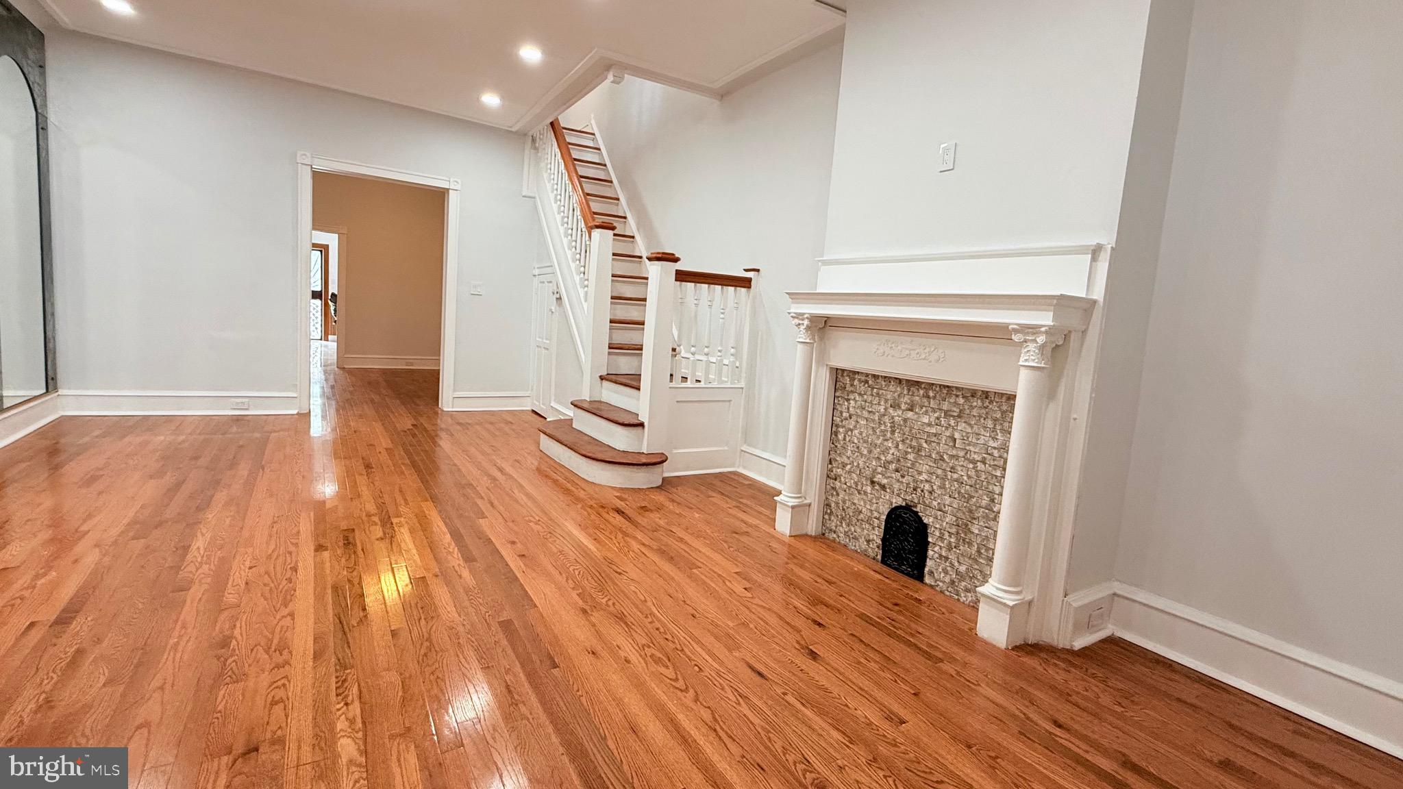 1333 Colwyn Street Philadelphia, PA 19140 - Photo 5 of 38 a view of a livingroom with wooden floor and a fireplace