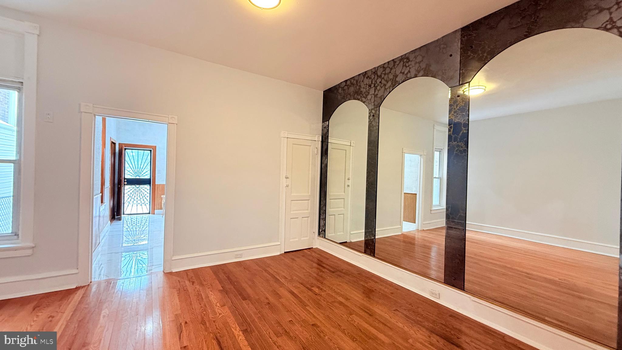 1333 Colwyn Street Philadelphia, PA 19140 - Photo 8 of 38 wooden floor in an empty room with a window