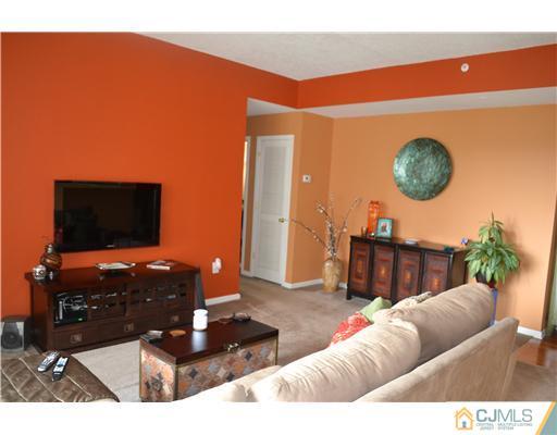 358 Rector Street, Unit 501 Perth Amboy, NJ 08861 - Photo 11 of 25 a living room with furniture and a flat screen tv