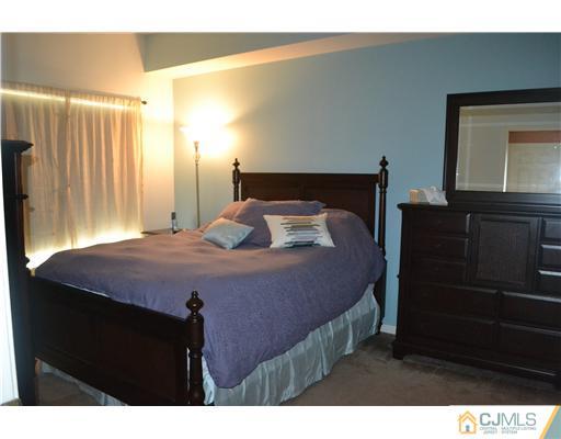 358 Rector Street, Unit 501 Perth Amboy, NJ 08861 - Photo 14 of 25 a bedroom with a bed and a dresser