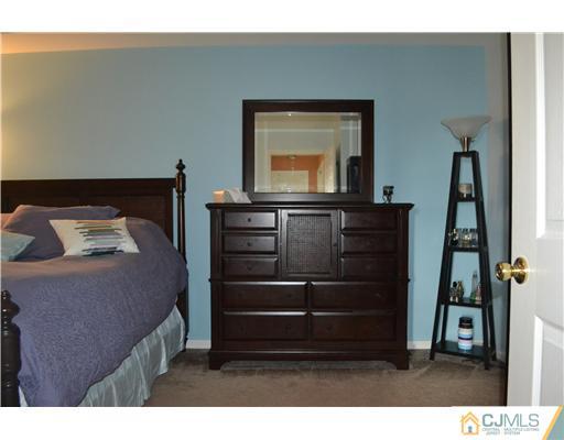 358 Rector Street, Unit 501 Perth Amboy, NJ 08861 - Photo 15 of 25 a bedroom with a bed and a mirror on the dresser