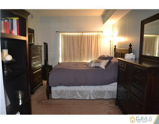 358 Rector Street, Unit 501 Perth Amboy, NJ 08861 - Photo 16 of 25 a bedroom with a bed dresser and a large mirror