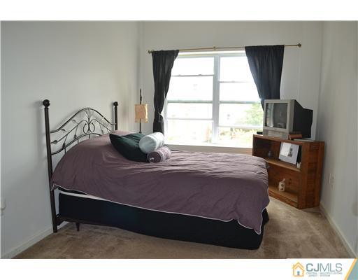 358 Rector Street, Unit 501 Perth Amboy, NJ 08861 - Photo 20 of 25 a bedroom with a bed window and a table
