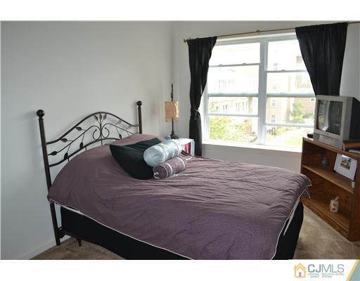 358 Rector Street, Unit 501 Perth Amboy, NJ 08861 - Photo 21 of 25 a bedroom with a bed and a large window