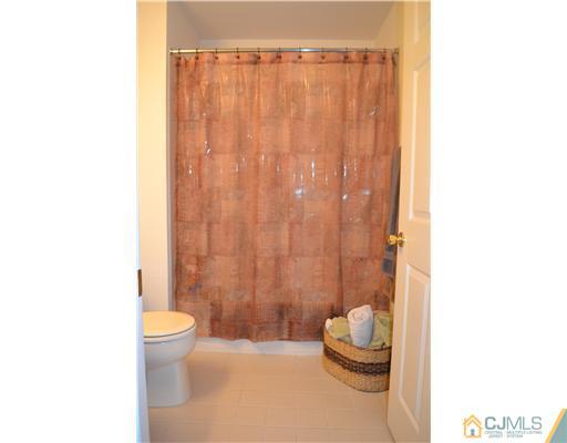 358 Rector Street, Unit 501 Perth Amboy, NJ 08861 - Photo 22 of 25 a bathroom with a toilet a sink and a shower