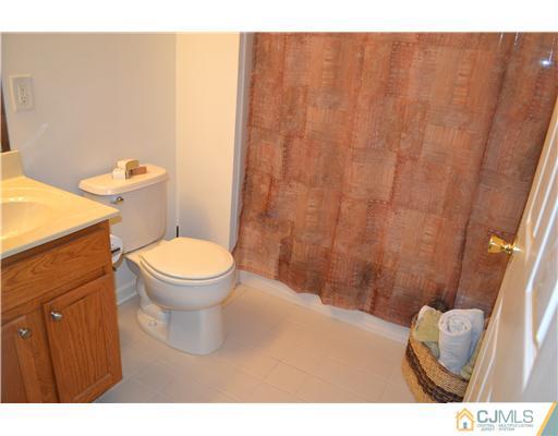 358 Rector Street, Unit 501 Perth Amboy, NJ 08861 - Photo 23 of 25 a bathroom with a toilet a sink and a shower