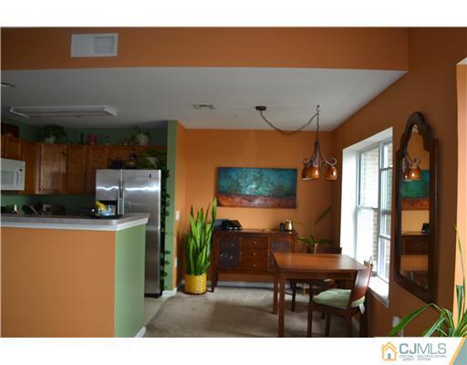 358 Rector Street, Unit 501 Perth Amboy, NJ 08861 - Photo 7 of 25 a living room with furniture a flat screen tv and a kitchen view
