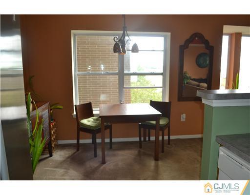 358 Rector Street, Unit 501 Perth Amboy, NJ 08861 - Photo 10 of 25 a view of a dining room with furniture and chandelier