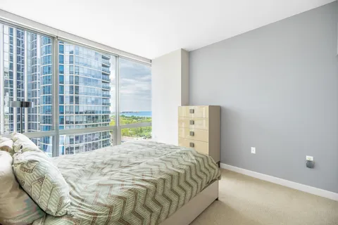 a bedroom with a bed and a large window