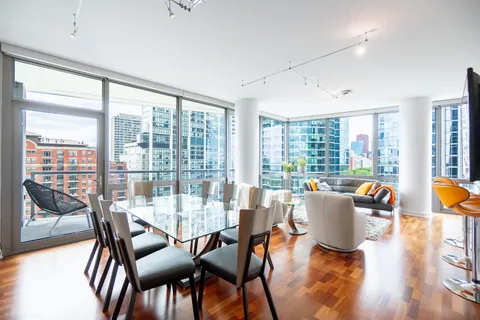 a dining room with furniture a window and wooden floor