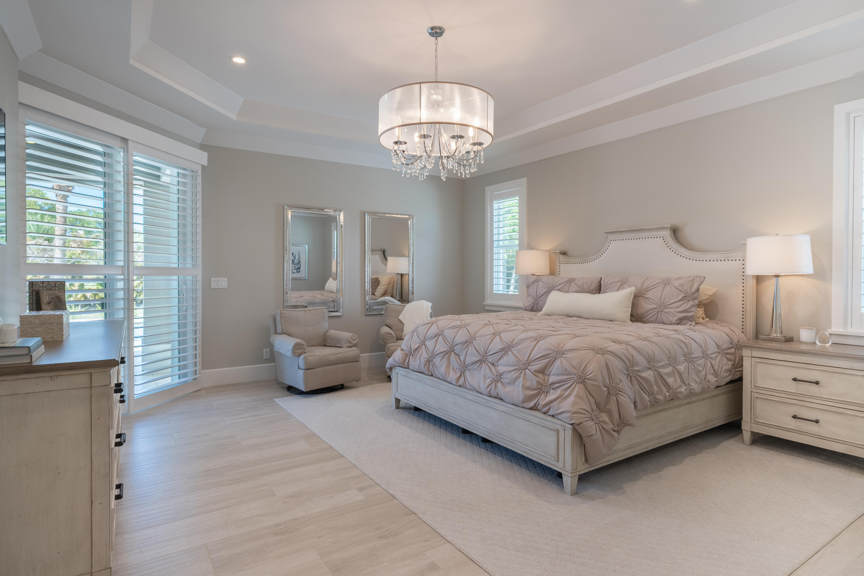 12275 185th Street North Jupiter, FL 33478 - Photo 16 of 35 a spacious bedroom with a bed and a chandelier