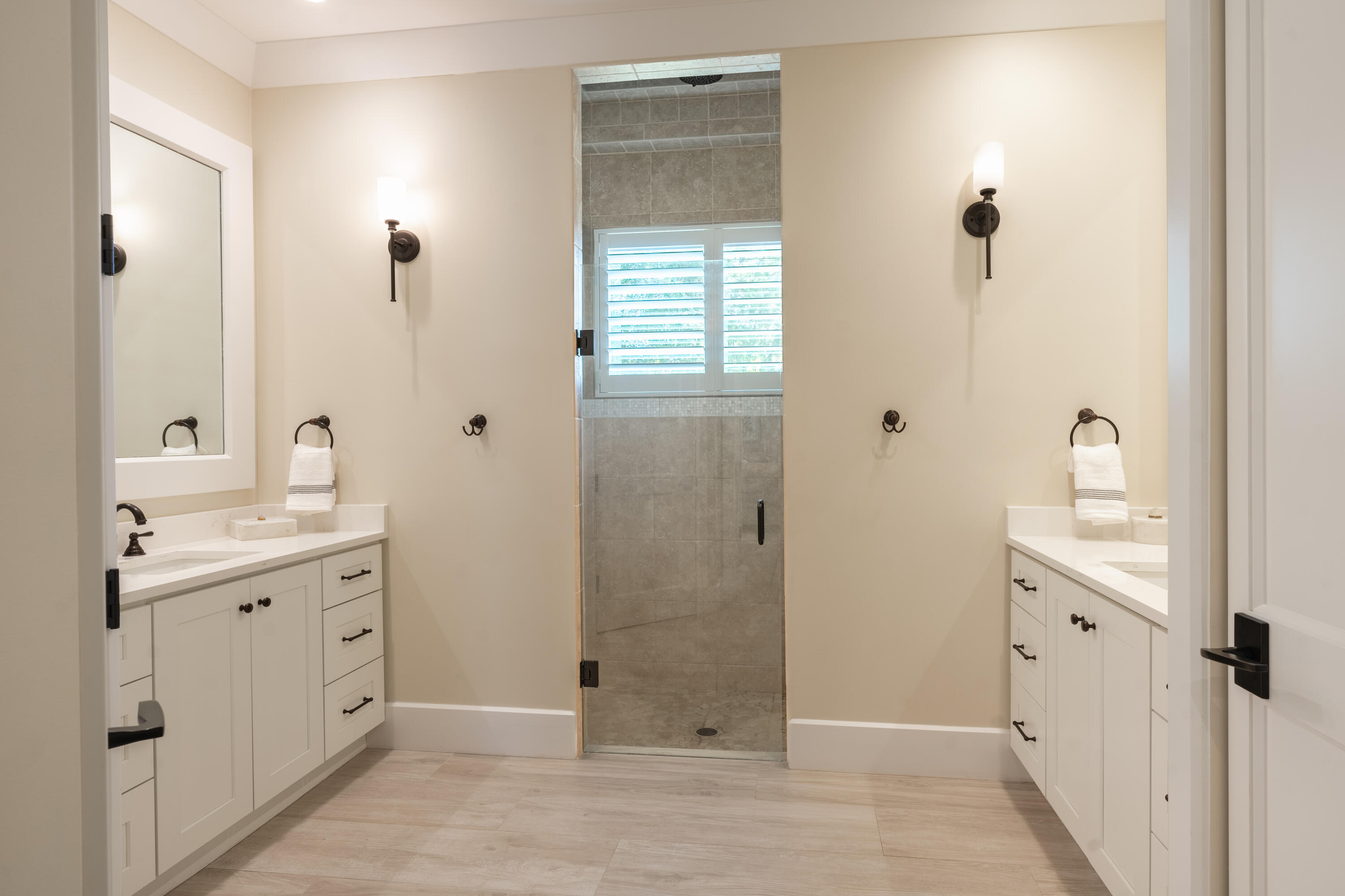 12275 185th Street North Jupiter, FL 33478 - Photo 19 of 35 a spacious bathroom with a granite countertop sink a mirror and a shower