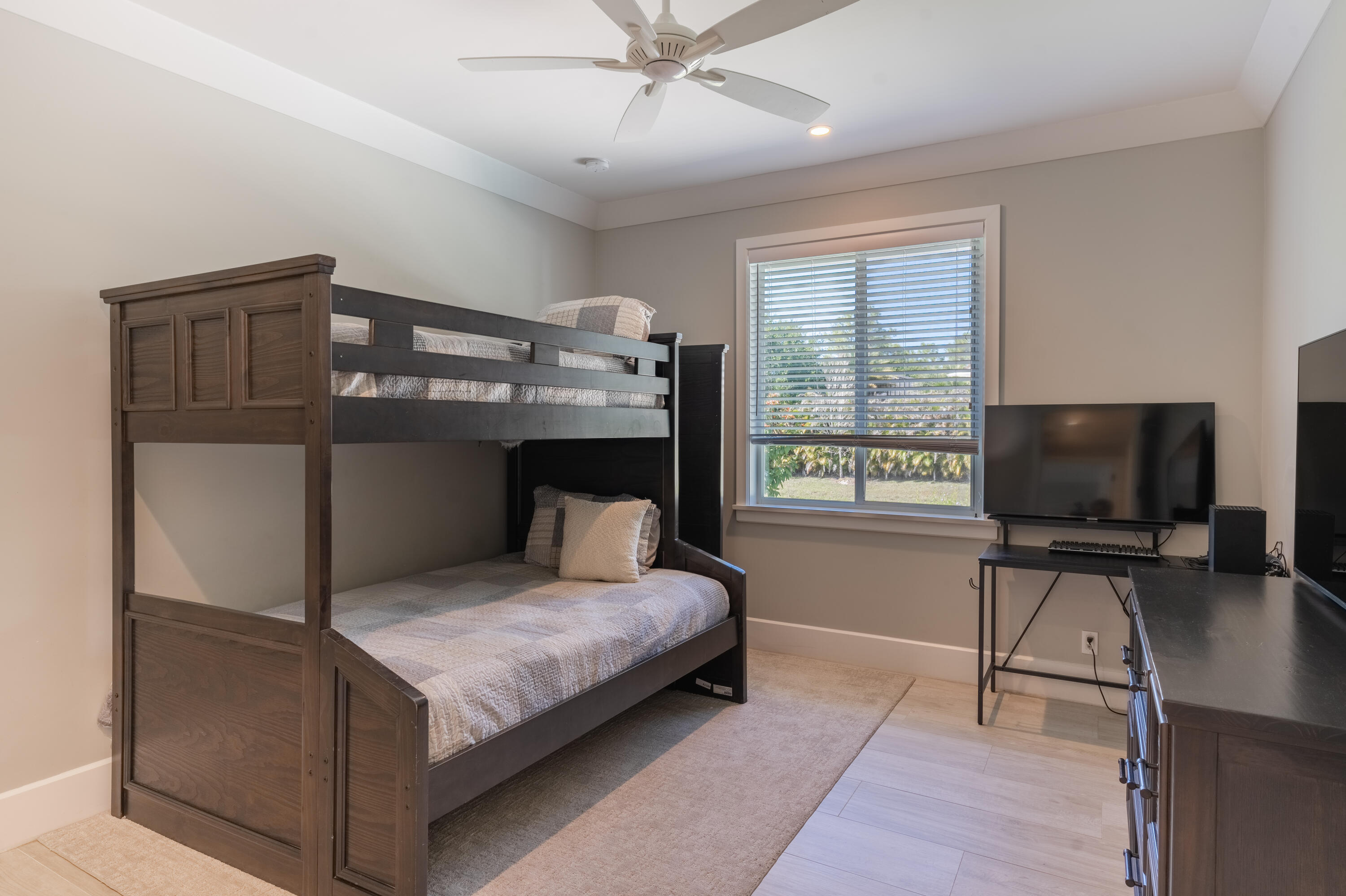 12275 185th Street North Jupiter, FL 33478 - Photo 20 of 35 a bedroom with a bed and a flat tv screen on the dresser
