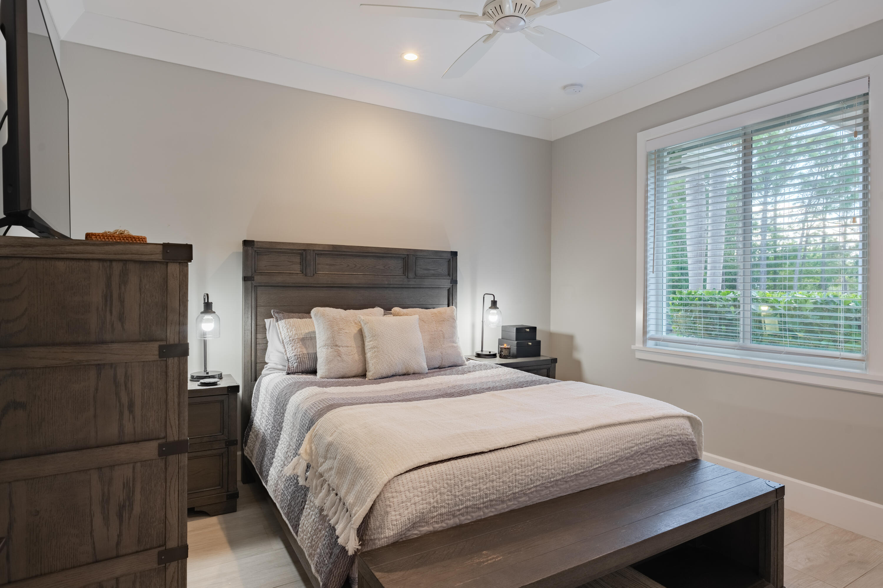 12275 185th Street North Jupiter, FL 33478 - Photo 21 of 35 a bedroom with a bed and a flat tv screen on a dresser