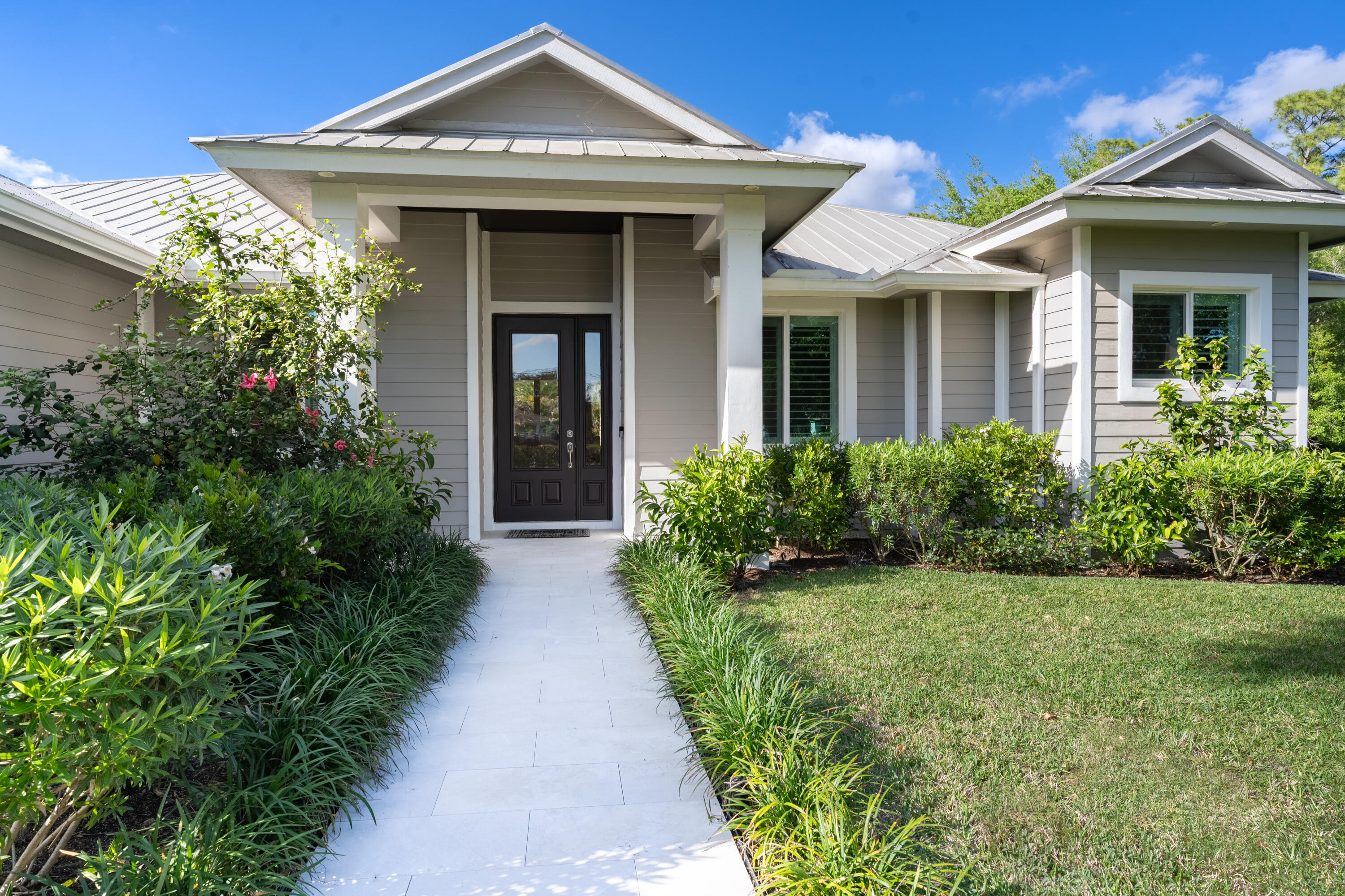 12275 185th Street North Jupiter, FL 33478 - Photo 5 of 35 a front view of a house with garden