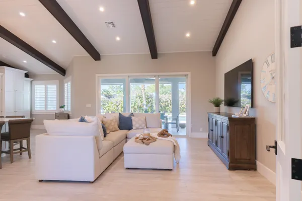 a bedroom with a bed and a flat tv screen on a dresser