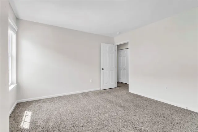 a view of an empty room and a window