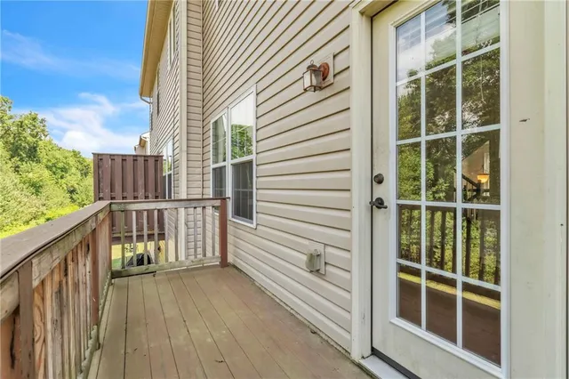 a view of balcony with a large window and wooden floor