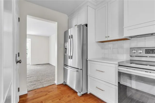 a kitchen with cabinets and stainless steel appliances