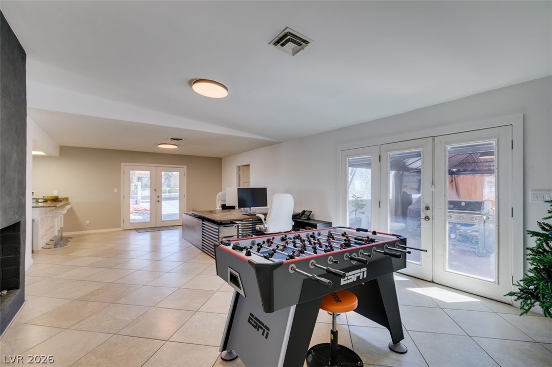 892 North Hollywood Boulevard Las Vegas, NV 89110 - Photo 31 of 81 This versatile room features expansive glass doors, inviting natural light and seamless indoor-outdoor living.