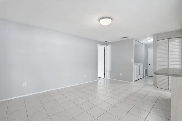 a kitchen with a sink window and cabinets