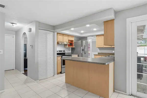 a kitchen with stainless steel appliances granite countertop a stove a sink and a microwave