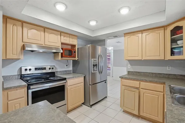 a kitchen with granite countertop white cabinets and sink