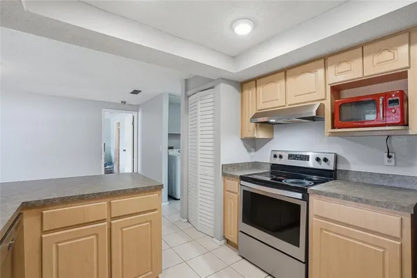 a kitchen with granite countertop white cabinets and window