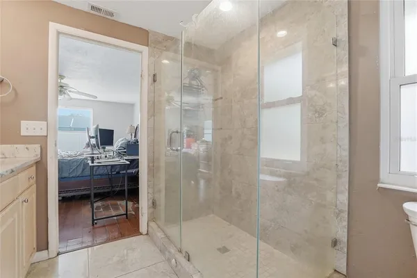 a bedroom with furniture and a chandelier