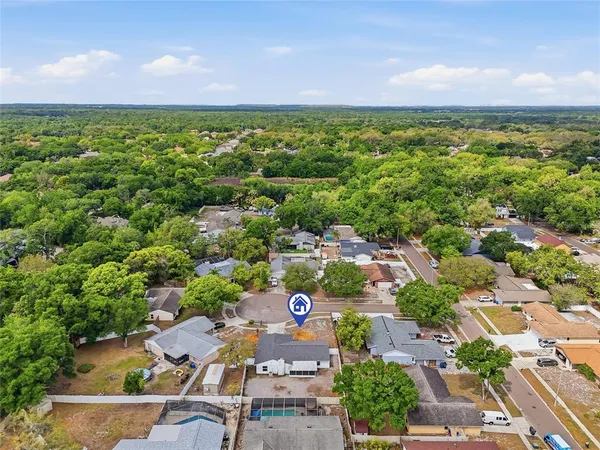 an aerial view of a house with a yard