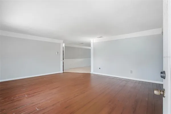 an empty room with wooden floor
