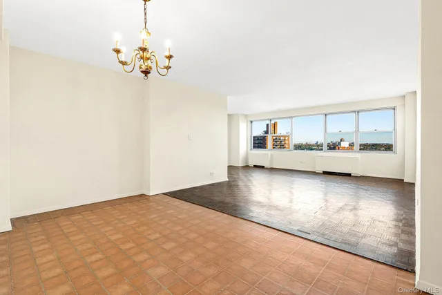 a spacious bedroom with a bed and a window
