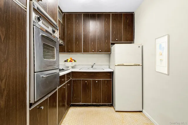 a kitchen with a sink cabinets and appliances