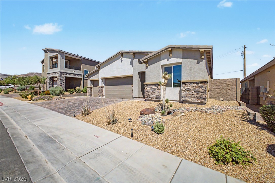 226 Augusta Ridge Henderson, NV 89015 - Photo 4 of 47 This modern home features a welcoming facade with a well-maintained xeriscape.