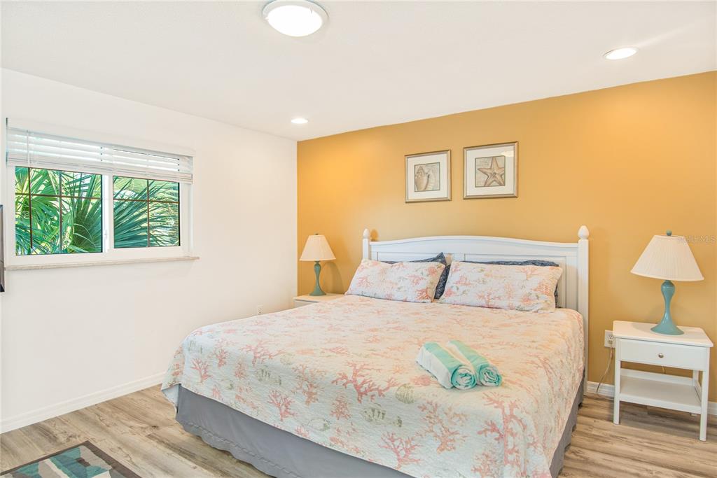 217 Casey Key Road Nokomis, FL 34275 - Photo 14 of 51 a bedroom with a bed and a painting on the wall