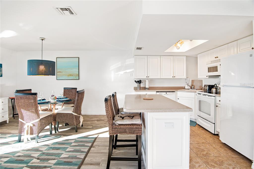 217 Casey Key Road Nokomis, FL 34275 - Photo 16 of 51 a kitchen with stainless steel appliances kitchen island a white cabinets and chair
